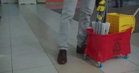 Cleaner work at the mall. Wash floor with the mop. Stock-Footage 138096016