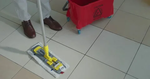 Cleaner work at the mall. Wash floor with the mop. Stock Footage 138096583