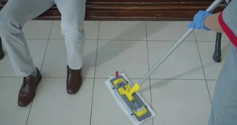 Cleaner work at the mall. Wash floor with the mop. Stock-Footage 138096674