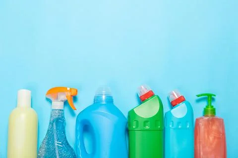 Cleaning agent on a blue background on the side. Professional cleaning produc Stock Photos