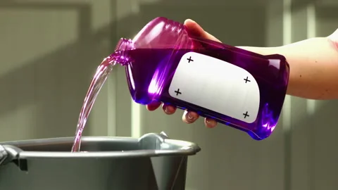 Cleaning agent from purple buttle added to a bucket GT0673 Video stock 130881872