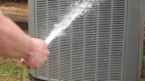 Cleaning Air Conditioner Coils on Outdoor Unit to Improve Efficiency Stock Footage 332721753