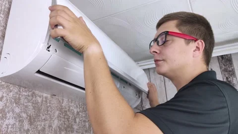 Cleaning the air conditioner from dust, mold and dirt. An air conditioner mainte Stock Footage 137623682