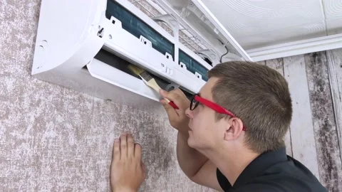 Cleaning the air conditioner from dust, mold and dirt. An air conditioner mainte Stock Footage 137623895
