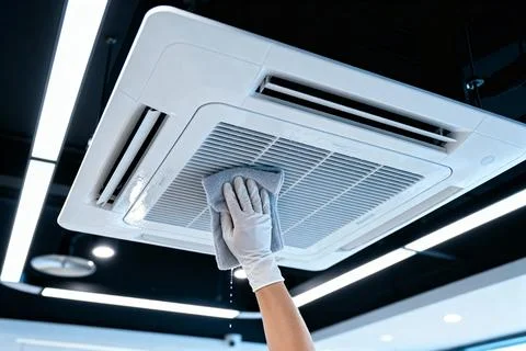 Cleaning an air conditioning unit with a microfiber cloth Stock Photos