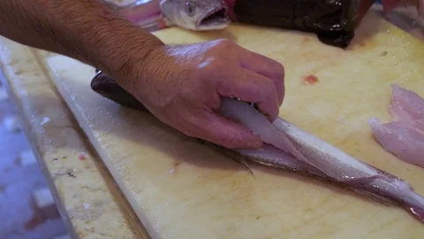 Cleaning and cutting a fish Video stock 117920311