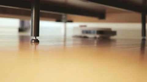Cleaning and mopping under the bed by an robot cleaner. Video stock 194405661