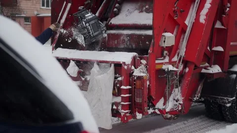 Cleaning and sorting garbage into a garbage truck in winter in the city. Slow Stock Footage 293684488