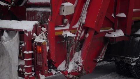 Cleaning and sorting garbage into a garbage truck in winter in the city. Slow Stock Footage 296580535