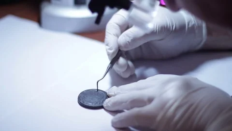 Cleaning antique Coins  Stock Footage 70519008