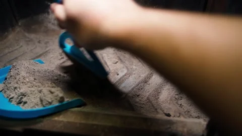 Cleaning ashes from a fireplace with a small broom and dustpan, close-up Stock Footage 321828380