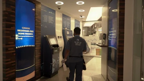 Cleaning ATM machine corona virus. A group of people standing in front of a Stock Footage 128840486