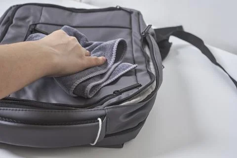 Cleaning backpack with washcloth Stock Photos