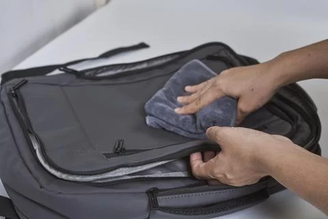 Cleaning backpack with washcloth Stock Photos