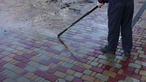 Cleaning backyard paving tiles with high pressure washer. Spring clean up Stock-Footage 194486091