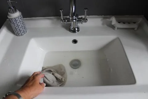 Cleaning the bathroom sink Stock Photos