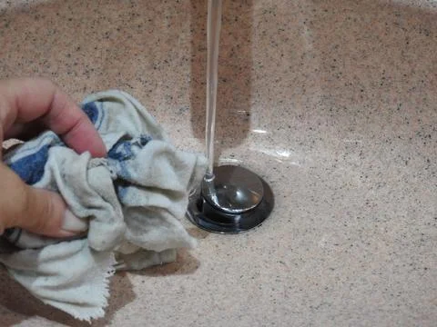 Cleaning the bathroom sink Stock Photos