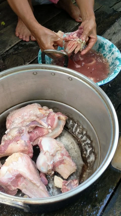 Cleaning beef bones for cooking soup Stock Footage 310997260