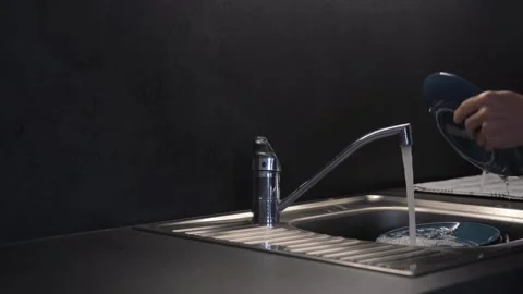 Cleaning blue plate on black background Stock Footage 281526136