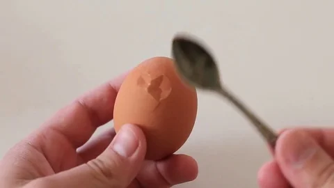 Cleaning of boiled chicken eggs from shell Stock Footage 84656468