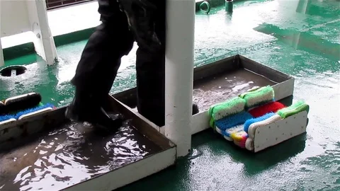 Cleaning Boots on Ship Stock Footage 125770944