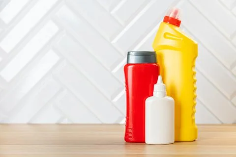 Cleaning bottles for different surfaces in kitchen, bathroom and other rooms. Stock Photos