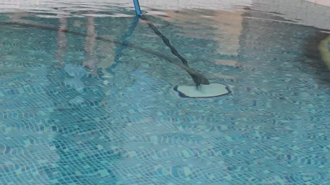 Cleaning the bottom of the pool with a special mop 스톡 동영상 88137597