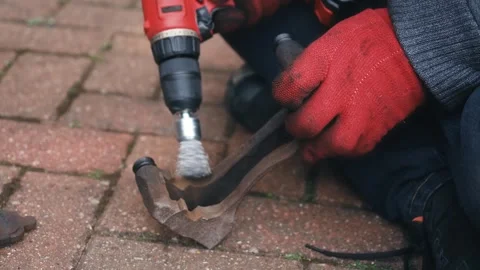 Cleaning brake caliper pad abutment surfaces with rotary wire brush during brake Stock Footage 335368934