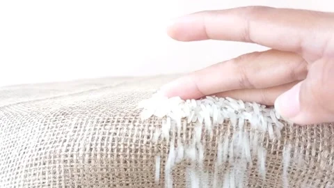Cleaning a brown table from a bunch of rice Stock Footage 145622935
