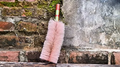 Cleaning Brush Against Rustic Wall Household Tool with Textured Background Stock Footage 332234962
