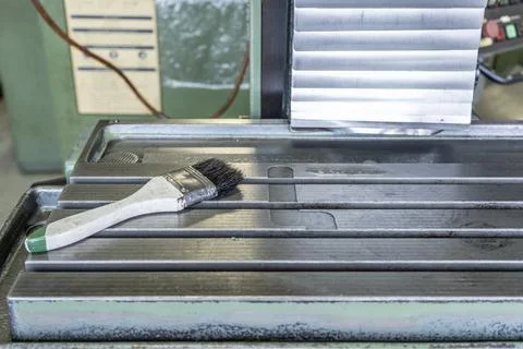 Cleaning brush on cnc machine table workshop Stock Photos
