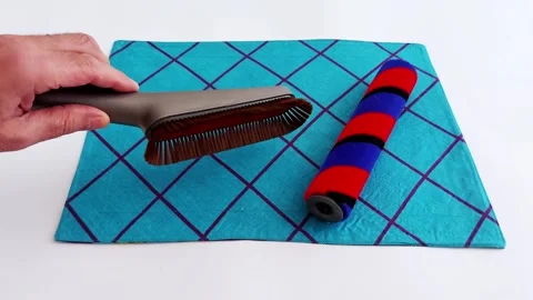 Cleaning Brush Roller Glide Across Blue Cloth in Soft Detail Stock Footage 313469738