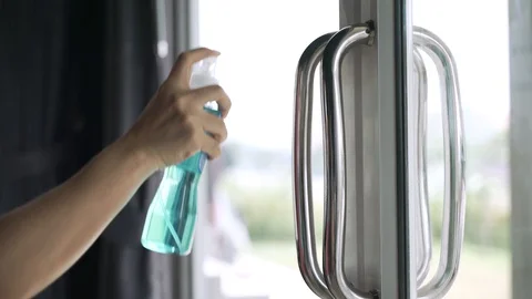 Cleaning building entry door handle with spray alcohol Video stock 128788830