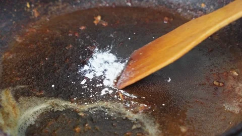 Cleaning burnt fat from surface of frying pan. Stock Footage 293502647