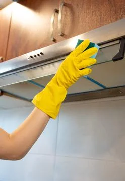 Cleaning cabinet underside with cloth Stock Photos