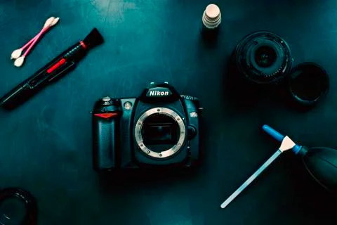 Cleaning the camera with black background. Stock Photos