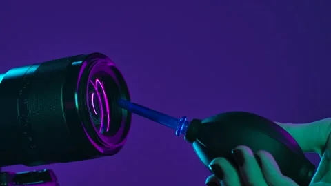Cleaning the camera lens with an air bulb Stock Footage 322170692