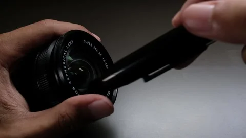 Cleaning a camera lens with a brush tool Stock Footage 263793998