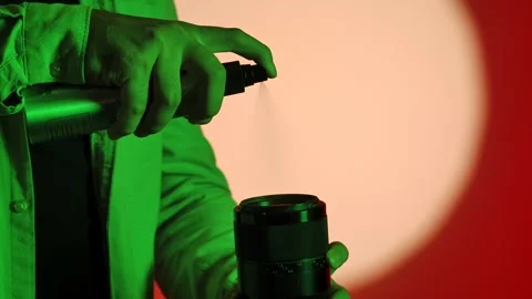 Cleaning Camera Lens with Spray Bottle and Hands 스톡 동영상 334108871