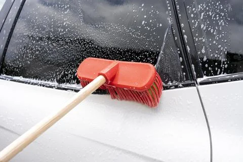 Cleaning a car with a brush Stock Photos