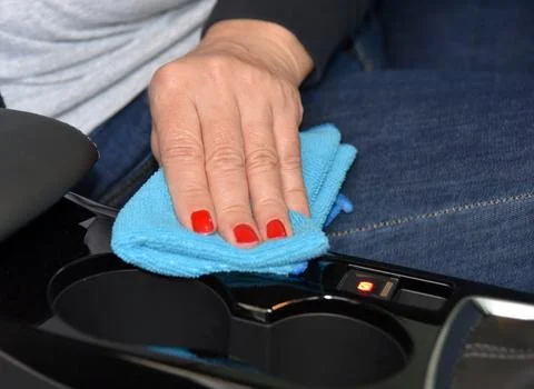 Cleaning the car console with a microfiber cloth Stock Photos