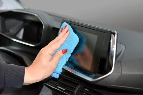 Cleaning the car console with a microfiber cloth Foto stock