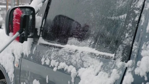 Cleaning a car from snow with a brush on a cold winter day. Winter season Stock Footage 209247458