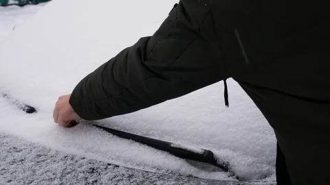 Cleaning the car from the snow Stock Footage 100912932