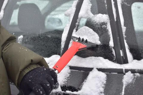 Cleaning the car from snow Stock Photos