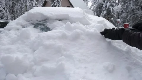 Cleaning a Car from Snow with A Plastic Scraper Video stock 292446443