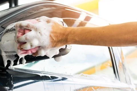 Cleaning a car with sponge Stock Photos