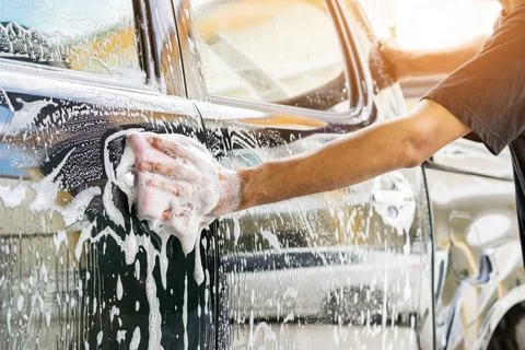 Cleaning a car with sponge Stock Photos