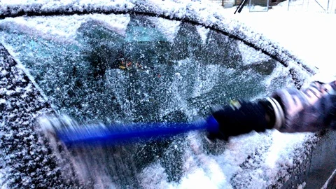 Cleaning car window from snow at winter 4K Stock Footage 100686122