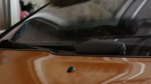Cleaning a Car Windshield with a Feather Duster Stock Footage 345335221